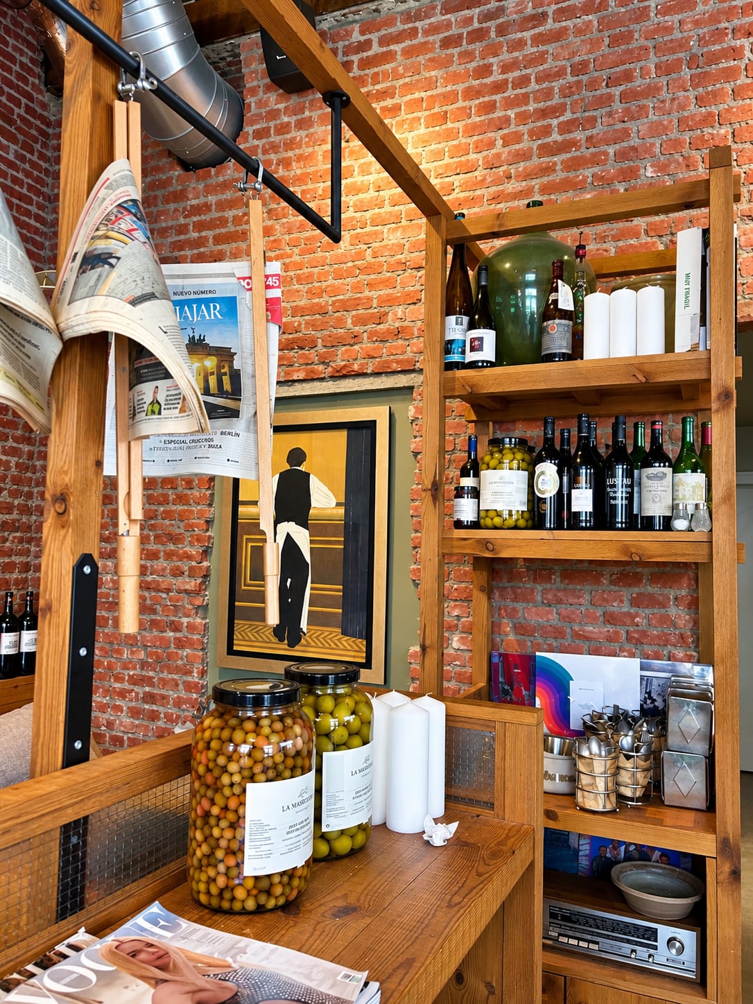 Brick walls, jars of olives and well-stocked wooden shelves inside Tabanco