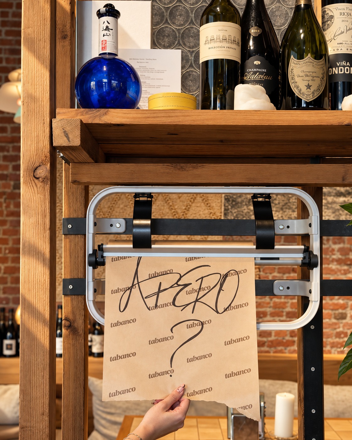 A handwritten apero sign held up at the bar